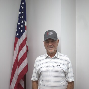 Tim Coldiron next to flag